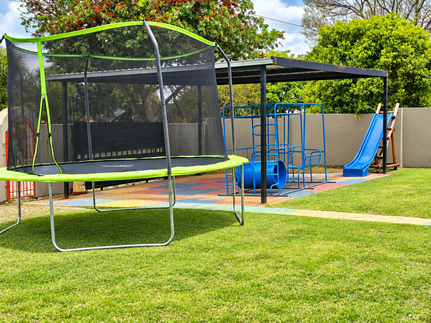 The shaded outdoor play area with climbing equipment